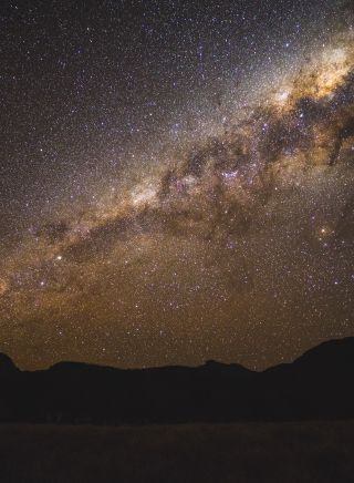 The starry Milky Way above the volcanic silhouette, Warrumbungles